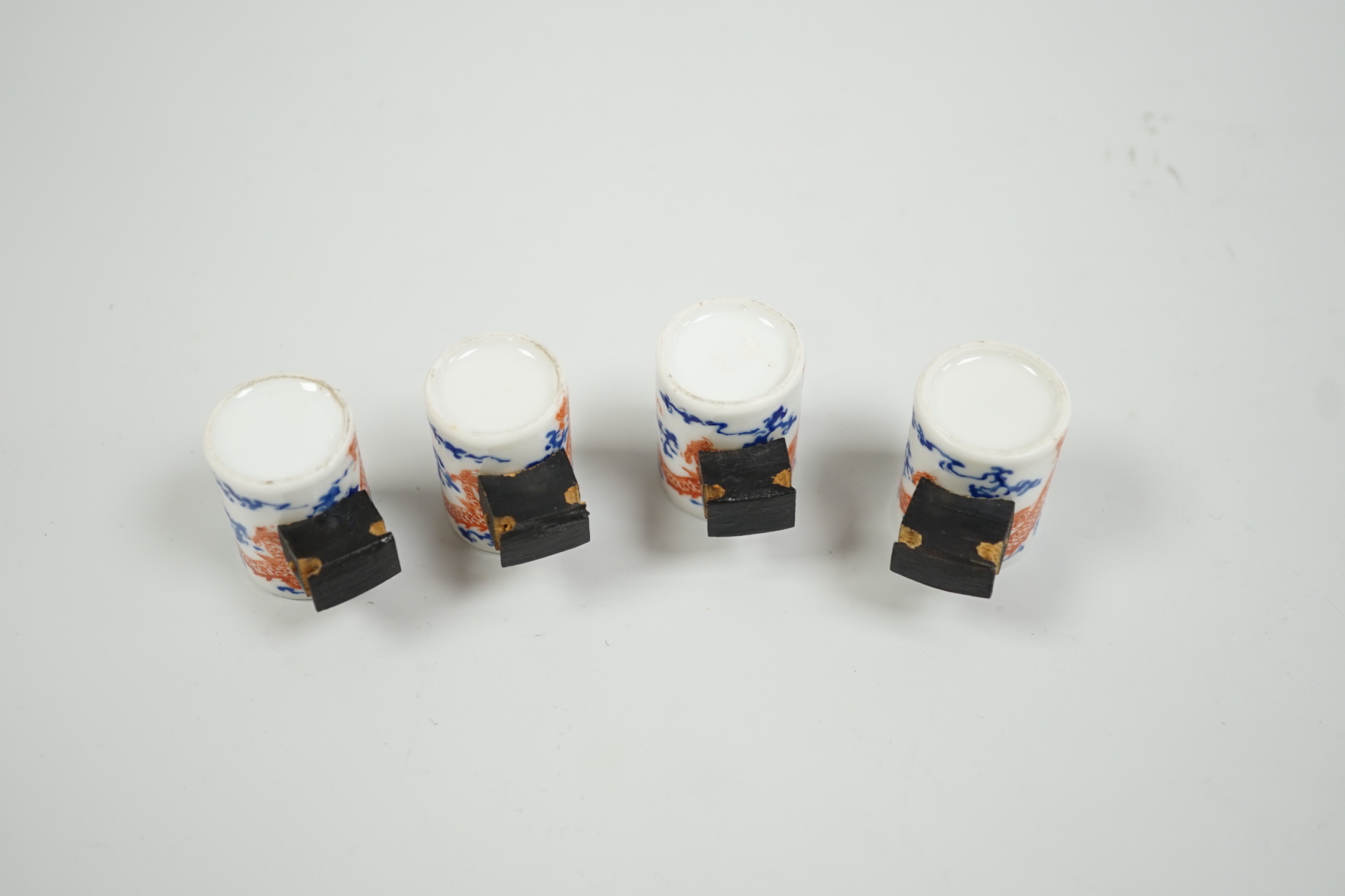 A set of four Chinese enamelled porcelain 'dragon' bird feeders, late 19th / early 20th century, 3.5cm high